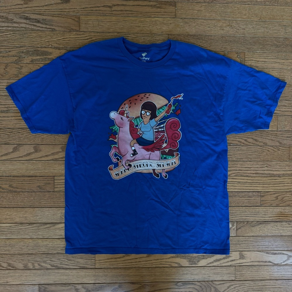 Bob’s Burgers Graphic Tee - Tina on a Unicorn with “Smart, Strong, Sensual”